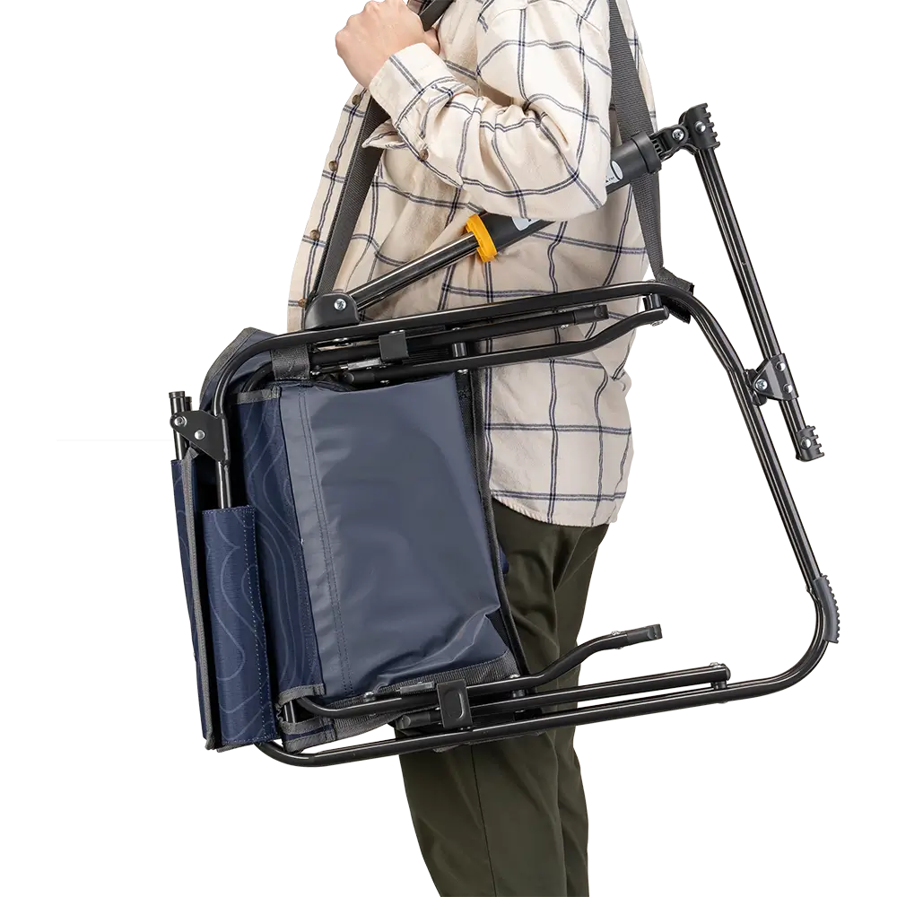 A person carrying the Navy Topo Stowaway Rocker with a carry strap. 
