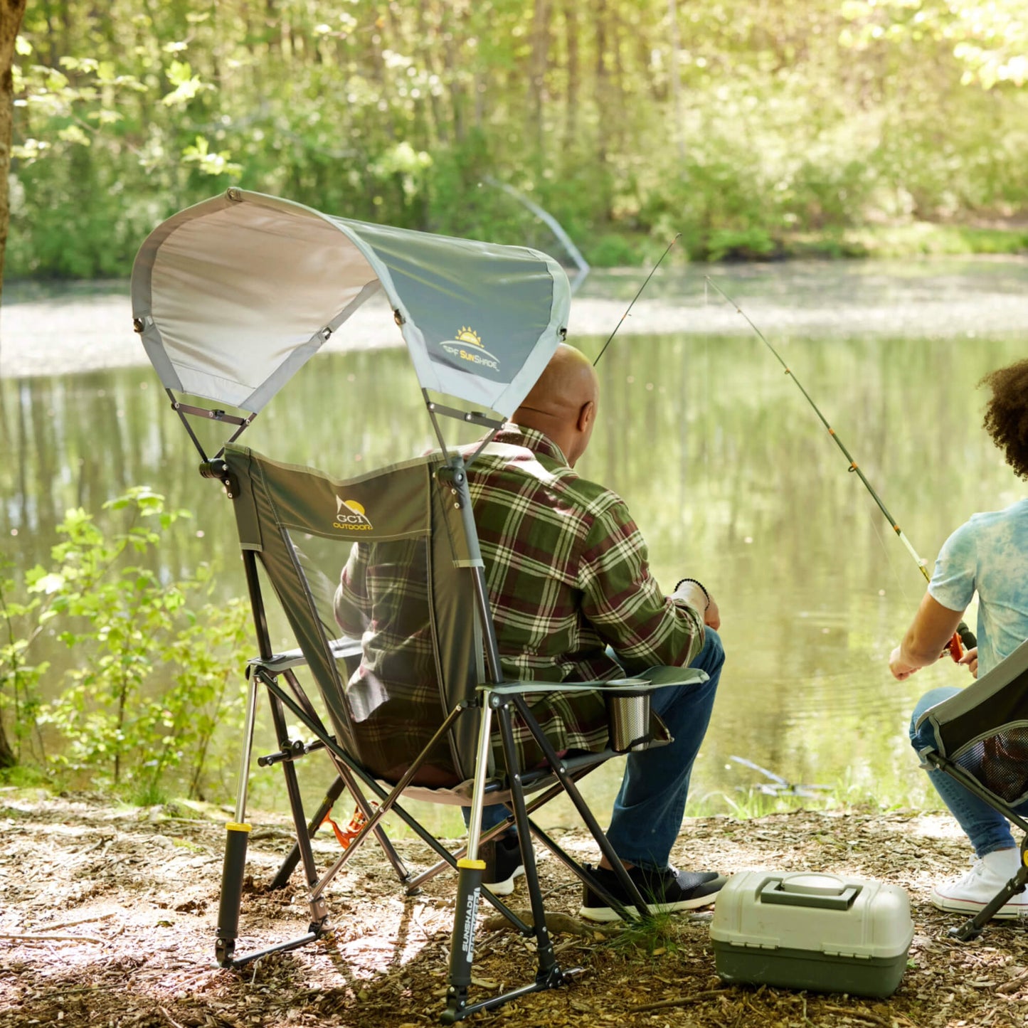 all-groups A man fishing with his daughter while sitting in a gray Sunshade Rocker. 