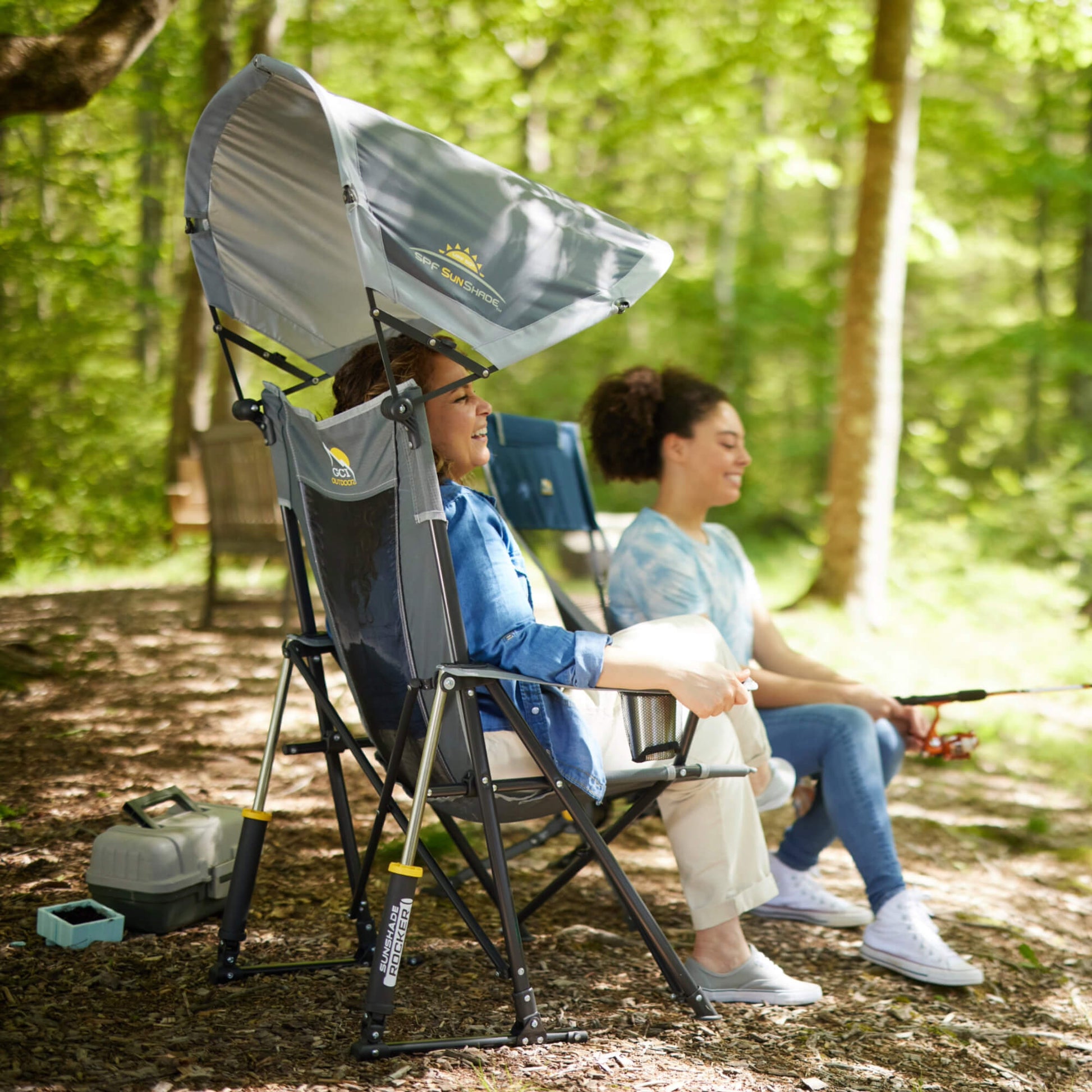 all-groups A woman smiling while watching her daughter fish while she sits in a Sunshade Rocker. 