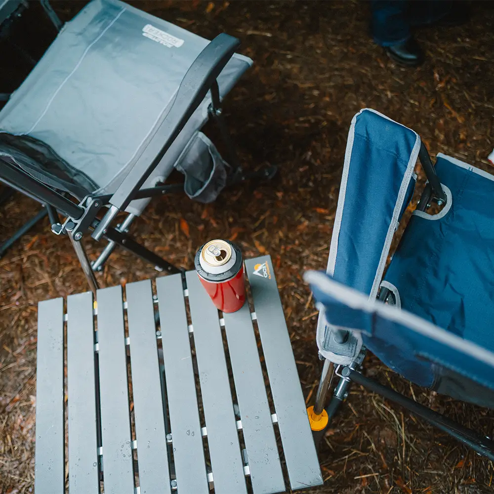Two gci chairs positioned next to the compact camp table. 