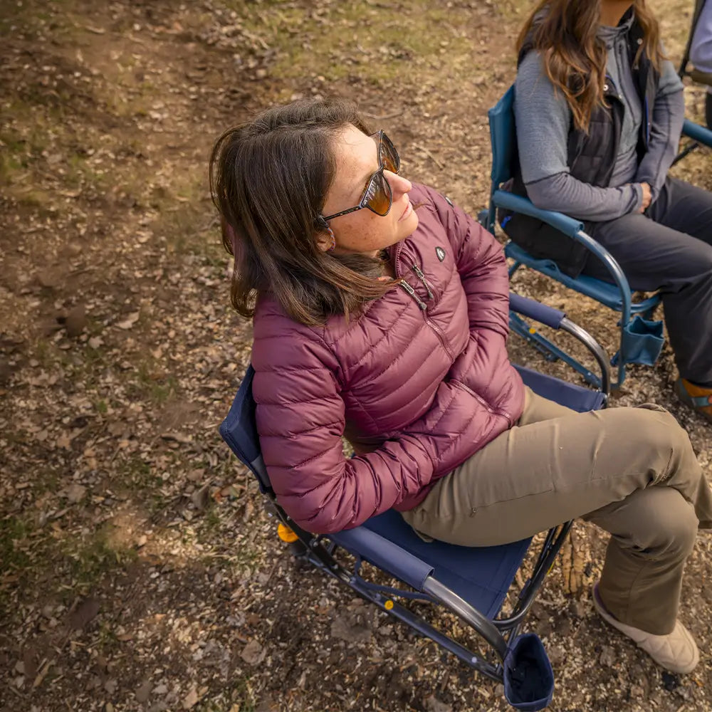 Overhead view of a person relaxing in a Teal Grab & Go Rocker at a campsite.