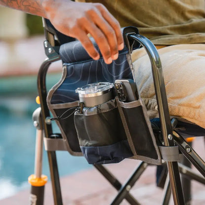 Close-up of Navy Topo Stowaway Rocker side storage pockets with a lantern and phone.